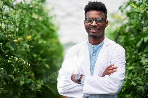 Preview: Portrait of a handsome young botanist posing with his arms folded outdoors in nature