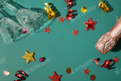Preview: Christmas new year flat lay with champagne, glass and stars, streamers