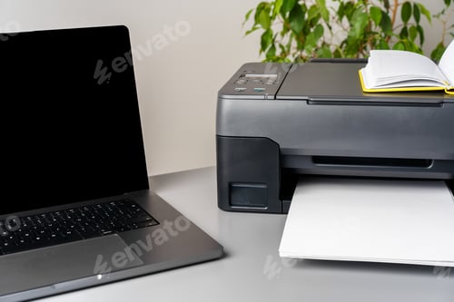 Preview: New modern printer and laptop in the office on table