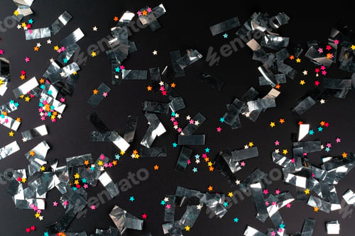 Preview: Silver sparkles tinsel on a black background