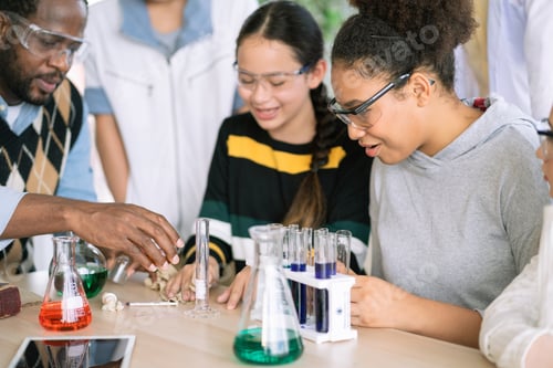 Preview: Group of students watching teacher showing science experiment