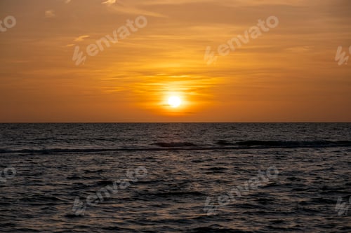 Preview: Ocean sunset. Big white sun on dramatic bright sky background, soft evening horizont