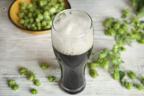 Preview: Composition with tasty beer and fresh green hops on wooden table