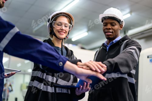 Preview: Portrait of technicians engineers team working at industrial factory