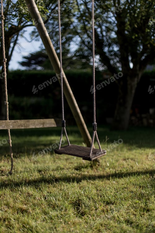Preview: Lonely backyard swing in the morning light