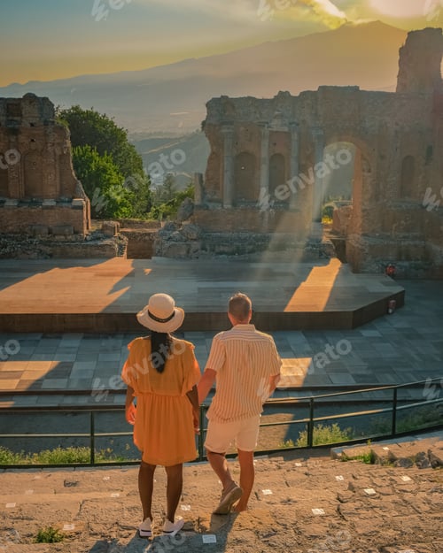 Preview: Taormina Sicily, couple watching sunset at the Ruins of the Ancient Greek Theater in Taormina