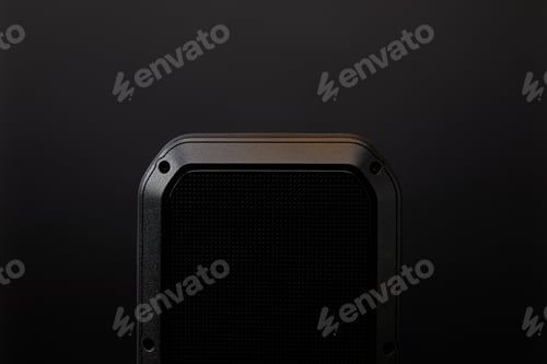 Preview: close up view of black audio speaker on black wall backdrop