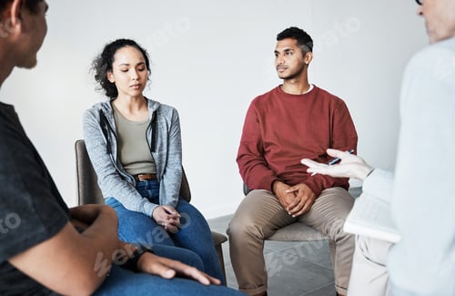 Preview: Close up of a young support group during meeting with professional therapist. Group of employees lo