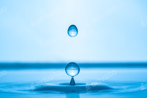 Preview: Water drop splashing into blue water surface