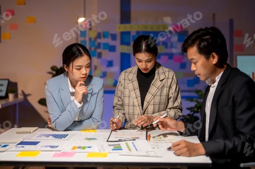 Preview: Three people are sitting at a table, looking at a presentation