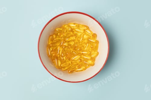 Preview: Omega 3. Vitamin E. Omega-3 capsules lying in a bowl on a white background
