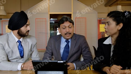 Preview: Group of Indian co-workers brainstorming during a business meeting