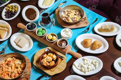 Preview: top view breakfast set olives cheese eggs with tomatoes jam sauces and tea on the table