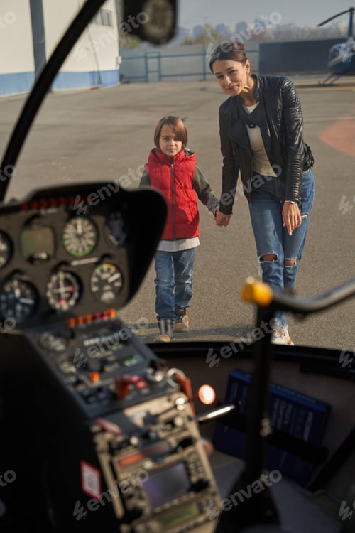 Preview: Mother and child approaching a plane with curiosity