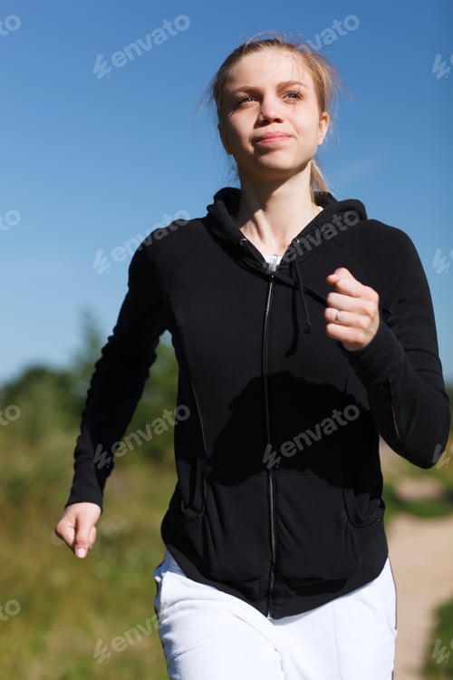 Preview: Girl running in the park. Close up