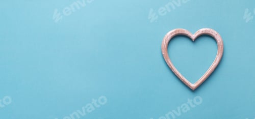 Preview: Wooden heart on a blue background with copy space. Simple concept for Valentine's day holiday