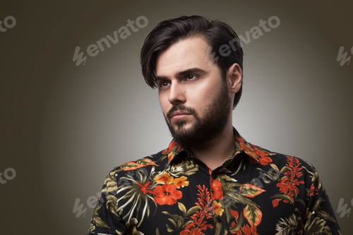 Preview: Young bearded hispanic male over isolated over white background with serious expression on face.
