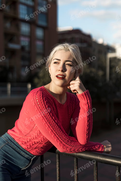 Preview: Young woman standing against the city