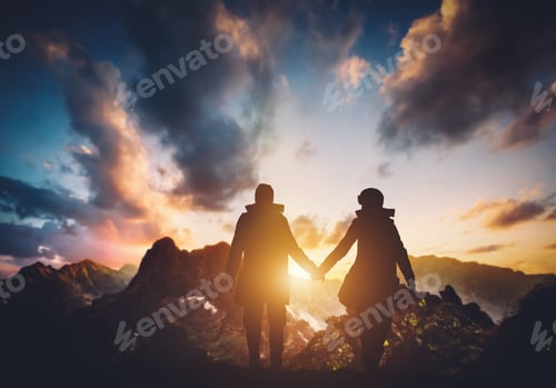 Preview: Couple walking in the mountains during sunset.