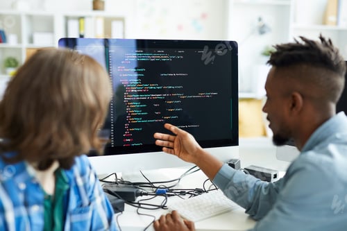 Preview: Busy colleagues analyzing computer code