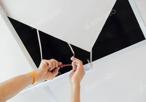 Preview: Adult hand male is repairing wire lamp