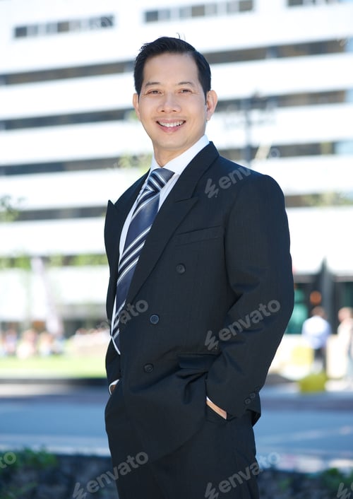Preview: Cheerful businessman posing outside