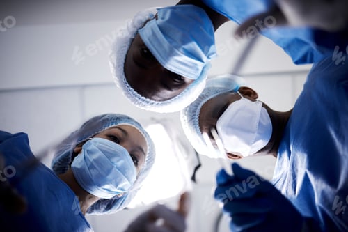 Preview: Medical Professionals In Blue Surgical Gear Overhead View