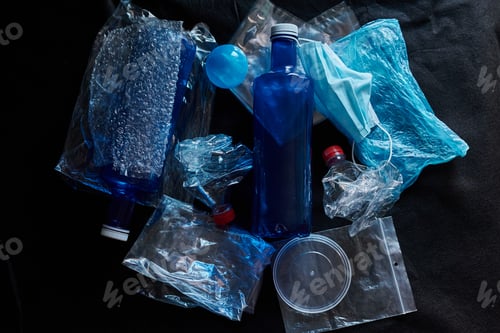 Preview: Piled plastic waste on a black background. Concept of pollution and environment
