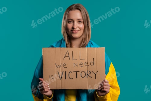 Preview: Ukrainian woman with cardboard All we need is victory on blue background.