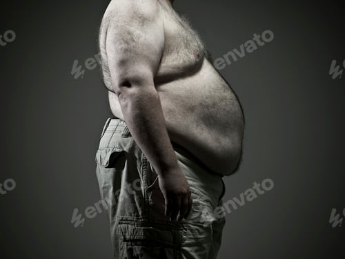 Preview: Side view of a shirtless overweight man standing against a grey background