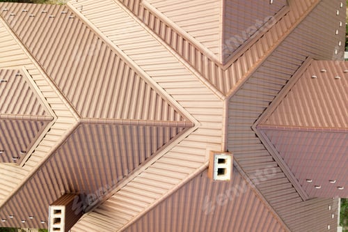 Preview: Aerial view of house roof structure covered with brown metal tile sheets.