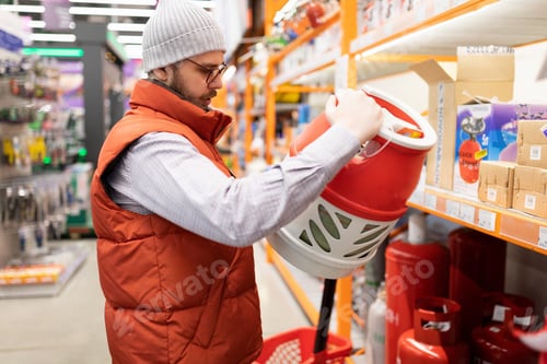 Preview: the buyer in the store chooses a gas cylinder for propane