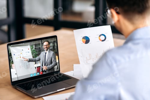 Preview: Caucasian male manager having online video conference with mature successful ceo