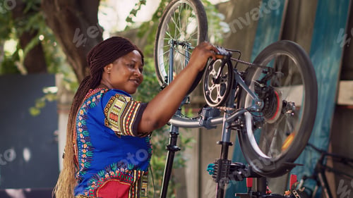 Preview: Smiling woman checking bike components