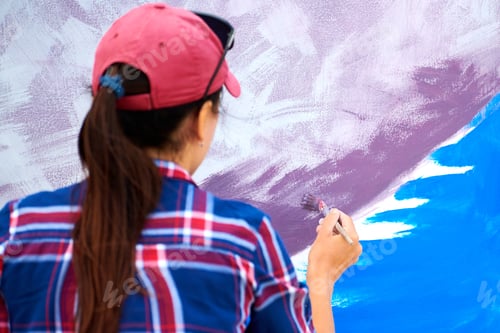 Preview: Female artist painting on wooden canvas board, painting abstract colorful picture, outdoor festival