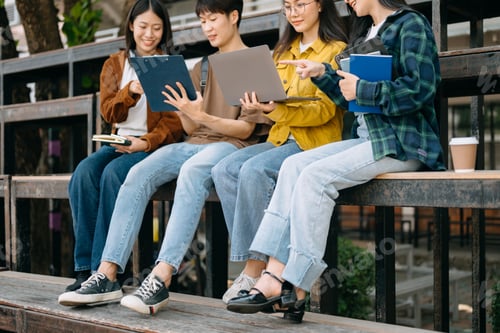 Preview: Young Asian People college students and a female student group work at the campus park