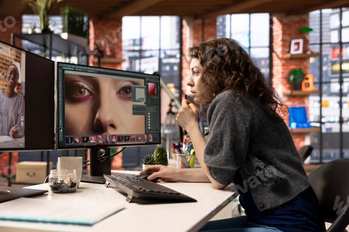 Preview: Female editor designer retouches photos on dual monitors desktop