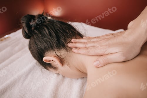 Preview: cropped view of masseur doing neck massage to woman in spa salon