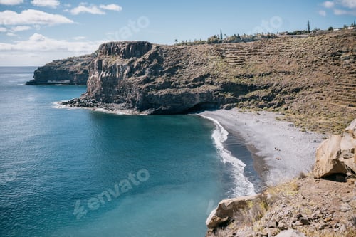 Preview: Rocky cliffs overlook over a secluded beach and ocean area, La Gomera, Canary Islands, Spain