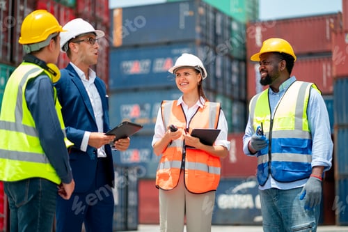 Preview: Group of multi ethnic cargo contianer workers stand and discuss together about the project