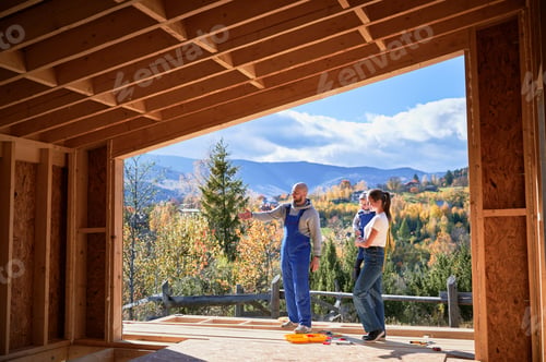 Preview: Father, mother and son building wooden frame house.