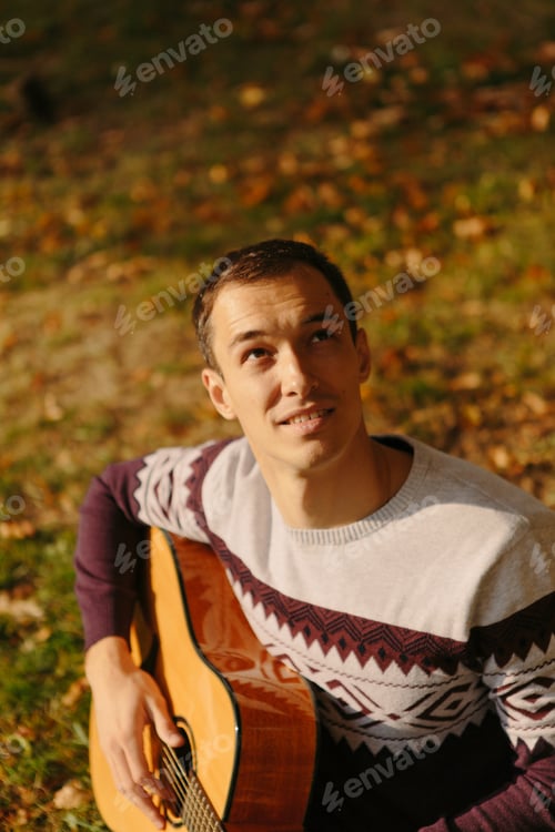 Preview: Handsome Guy With Guitar In The Autumn Park