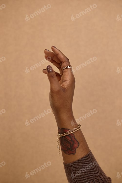 Preview: Black Womans Arm with Nude Manicure
