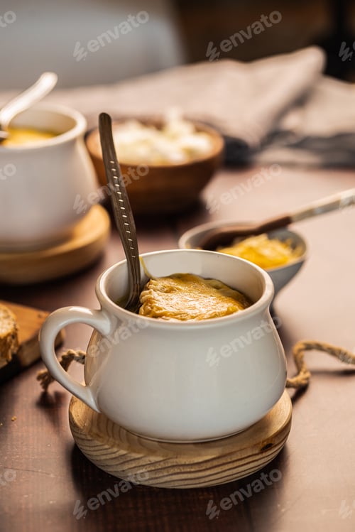 Preview: homemade onion soup on a wooden table