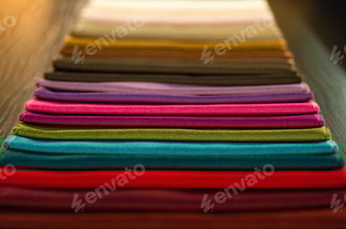 Preview: Colorful Fabric Samples Stacked Neatly on a Table