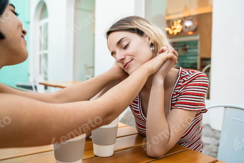Preview: Loving lesbian couple having a date at coffee shop.