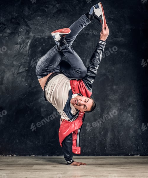 Preview: Emotional stylish dressed man performing break dance moves on the floor.