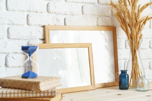Preview: Photo frames on a brick wall background on the table with wheat ears in vase