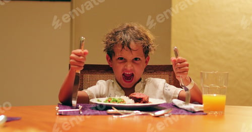 Preview: Barbarian Child Holding Fork And Knife And Grimicing To Camera