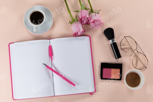 Preview: Make up view with pink flowers, notebook, cup of coffee and glasses on pink background
